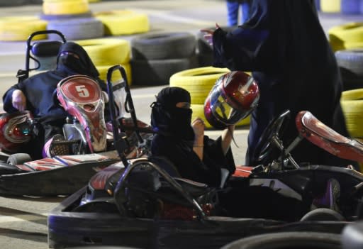 Saudi women attend an electronic driving simulator during a go-cart driving workshop for women in the capital Riyadh