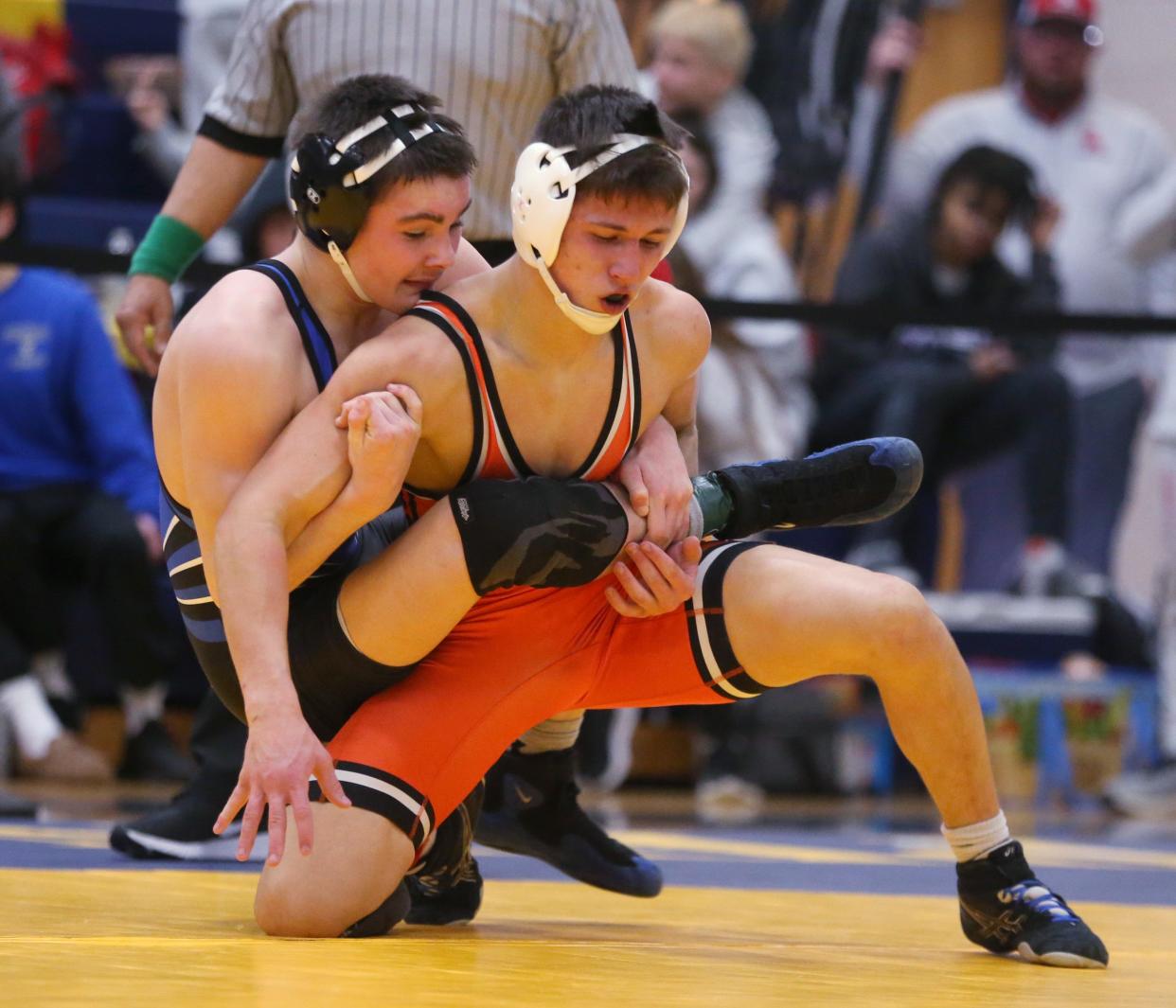 William Wood of Brockport, left, maintains control as Churchville-Chili's Cael Raines tries to get to his feet and escape during their 138-pound final at the 2023 Monroe County Championships.