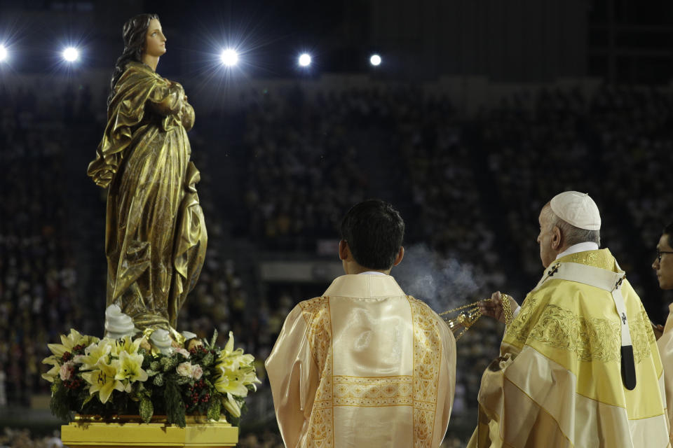 FILE - In this Nov. 21, 2019 file photo, Pope Francis blesses a statue of the Mother Mary as he celebrates Mass at the National Stadium, in Bangkok, Thailand. Pope Francis is giving his blessing to a new Vatican think tank that is seeking to prevent the Mafia and organized crime groups from exploiting the image of the Virgin Mary for their own illicit ends. (AP Photo/Gregorio Borgia)