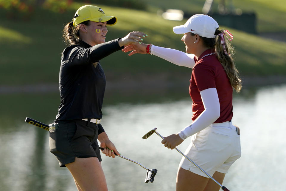 Oregon golfer Briana Chacon, left, hugs Stanford golfer Sadie Englemann after Chacon won her match during the NCAA college women's golf championship title match at Grayhawk Golf Club, Wednesday, May 25, 2022, in Scottsdale, Ariz. (AP Photo/Matt York)