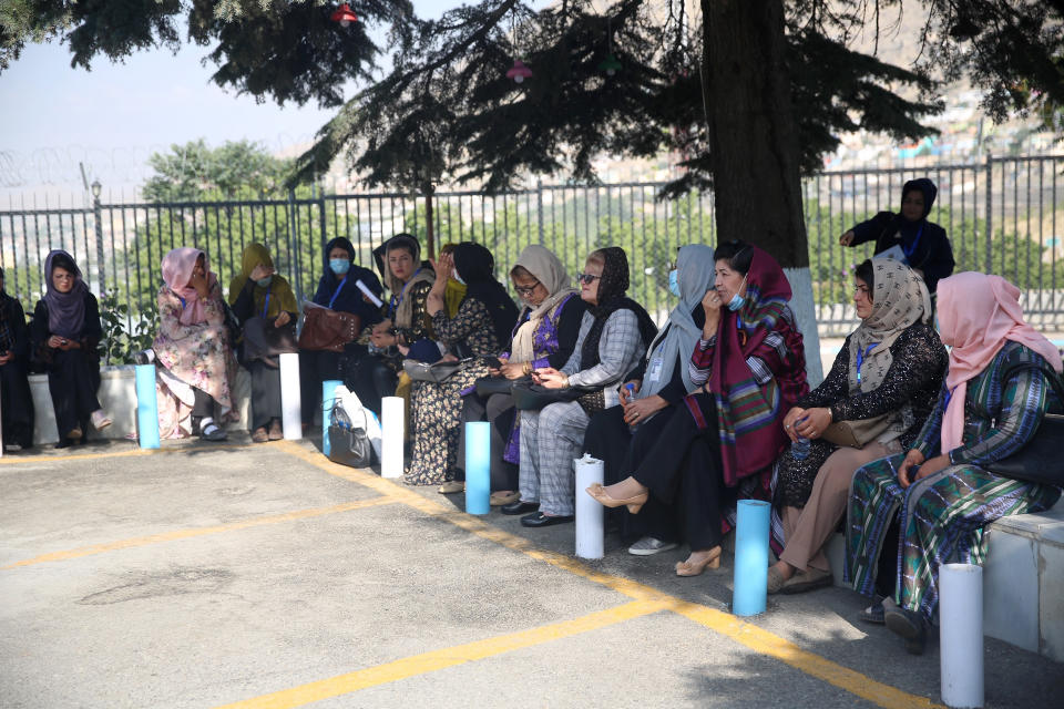 Delegates wait for transportation on the first day of the Afghan Loya Jirga meeting in Kabul, Afghanistan, Friday, Aug. 7, 2020. The traditional council opened Friday in the Afghan capital to decide the release of a final 400 Taliban - the final hurdle to the start of negotiations between Kabul’s leadership and the Taliban in keeping with a peace deal the United States signed with the insurgent movement in February. (AP Photo/Rahmat Gul)