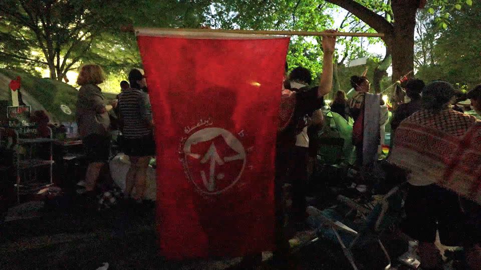 A protester holds a Popular Front for the Liberation of Palestine flag at the University of Pennsylvania on May 1. - CNN