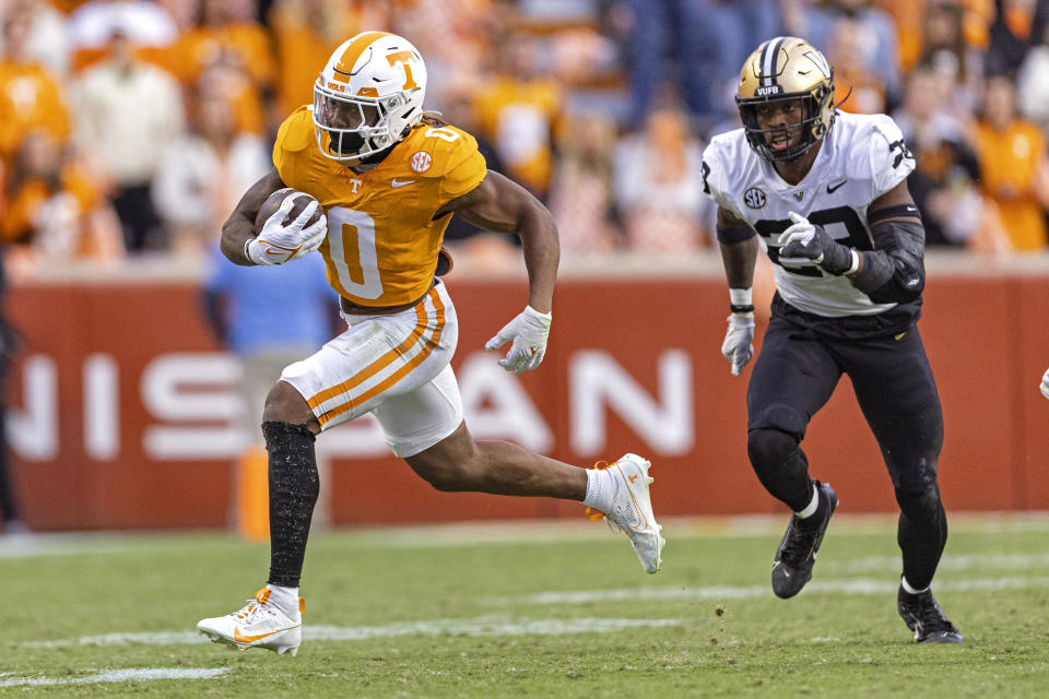 Tennessee running back Jaylen Wright (0) outruns Vanderbilt defensive back Miles Capers (29) during the first half of an NCAA college football game Saturday, Nov. 25, 2023, in Knoxville, Tenn. (AP Photo/Wade Payne)