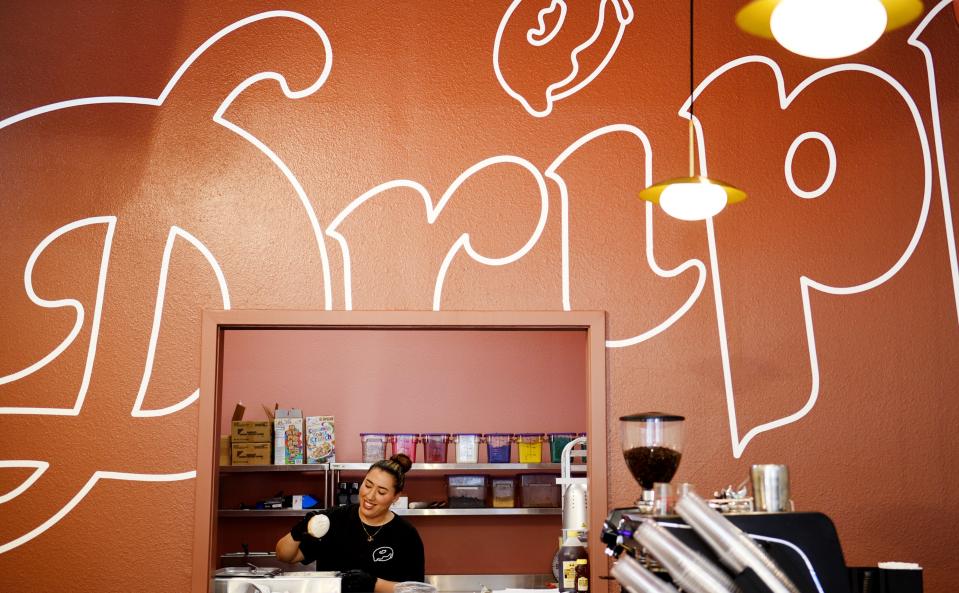 Soraya Karimi decorates a donut at Dripp Donuts in downtown Shreveport on February 28, 2023.