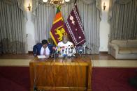 Sri Lanka's Parliament Speaker Mahinda Yapa Abeywardana, right, speaks during a press conference in Colombo, Sri Lanka, Friday, July 15, 2022. Abeywardana says President Gotabaya Rajapaksa has resigned and Parliament will convene to choose a new leader after massive protests took over government buildings to force him out of office. (AP Photo/Rafiq Maqbool)