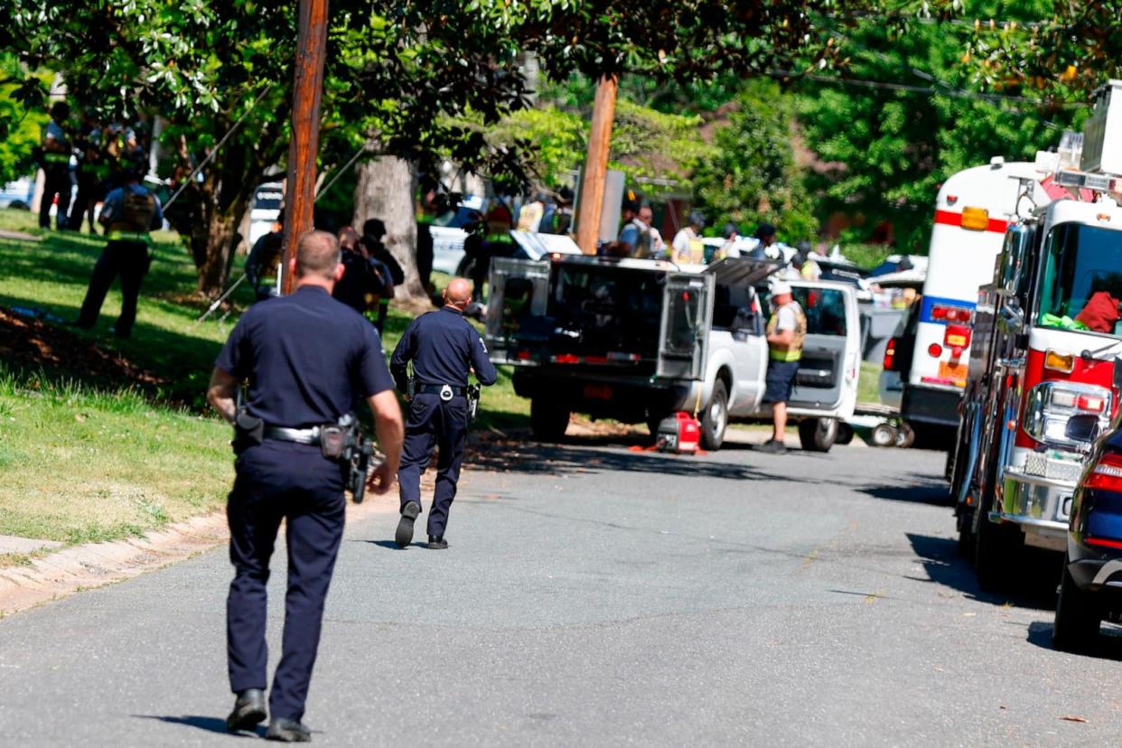 PHOTO: Charlotte Mecklenburg Police Department officers walk in the neighborhood where an officer-involved shooting took place in Charlotte, N.C., April 29, 2024. (Nell Redmond/AP)