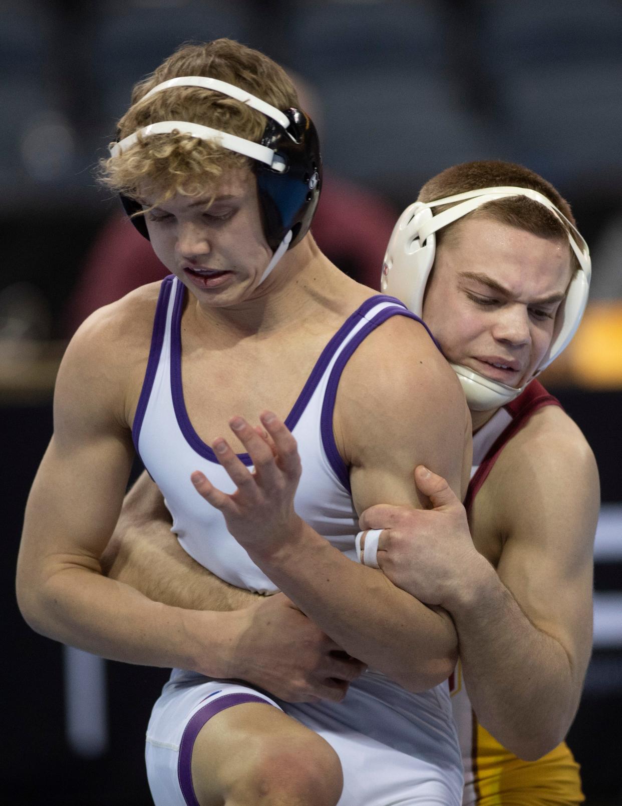 Brownsburg’s Braylon Reynolds and Evansville Mater Dei’s Isaiah Schaefer compete in the 126-pound championship match of the 2024 IHSAA Semi-State Wrestling tournament at Ford Center in Evansville, Ind., Feb. 10, 2024.