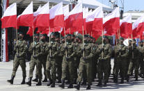 Polish soldiers hold national flags as Poland marks the centennial of the Battle of Warsaw, a Polish military victory in 2020 that stopped the Russian Bolshevik march toward the west, in Warsaw, Poland, Saturday Aug. 15, 2020. U.S. Secretary of State Mike Pompeo attended as he wrapped up a visit to central Europe. (AP Photo/Czarek Sokolowski)