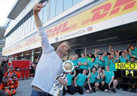 Formula One - Russian Grand Prix - Sochi, Russia - 1/5/16 Mercedes F1 driver Nico Rosberg of Germany shoots a selfie with the trophy and the Mercedes team. REUTERS/Maxim Shemetov