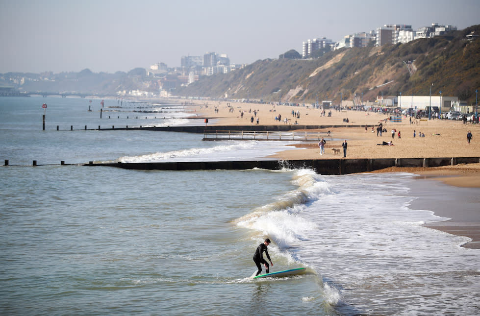 People enjoy the warm weather on Boscombe Pier in Dorset at the weekend (Picture: PA)
