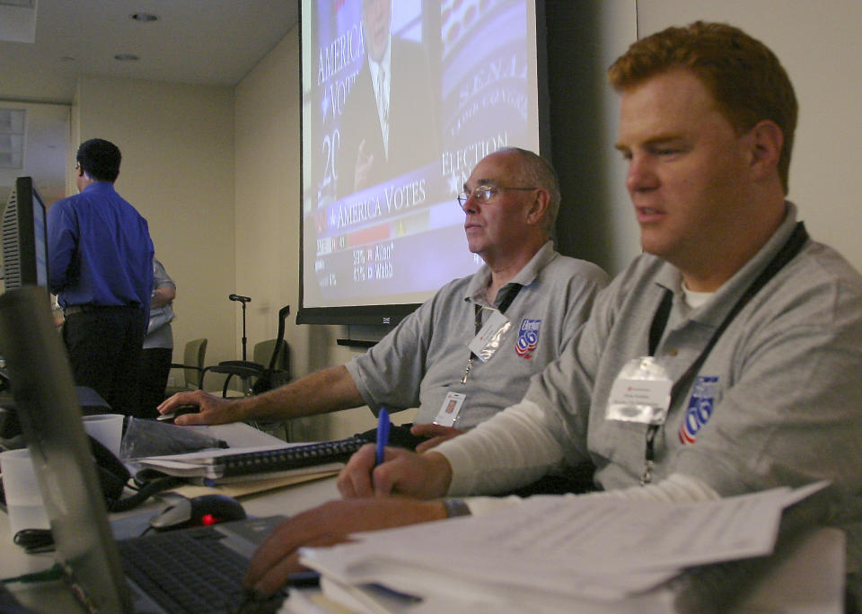 FILE - Tom Jory, center, works at the Eastern election center at New York headquarters on Tuesday Nov. 7, 2006. Jory, an editor who played a vital role in one of The Associated Press’ most crucial functions — counting the vote for U.S. elections — has died. He was 77. Samantha Deutsch, Jory’s daughter, said he died Monday, Dec. 6, 2021, at Manhattan’s Lenox Hill Hospital of complications after surgery for a broken hip suffered in October. (AP Photo/Santos Chaparro)