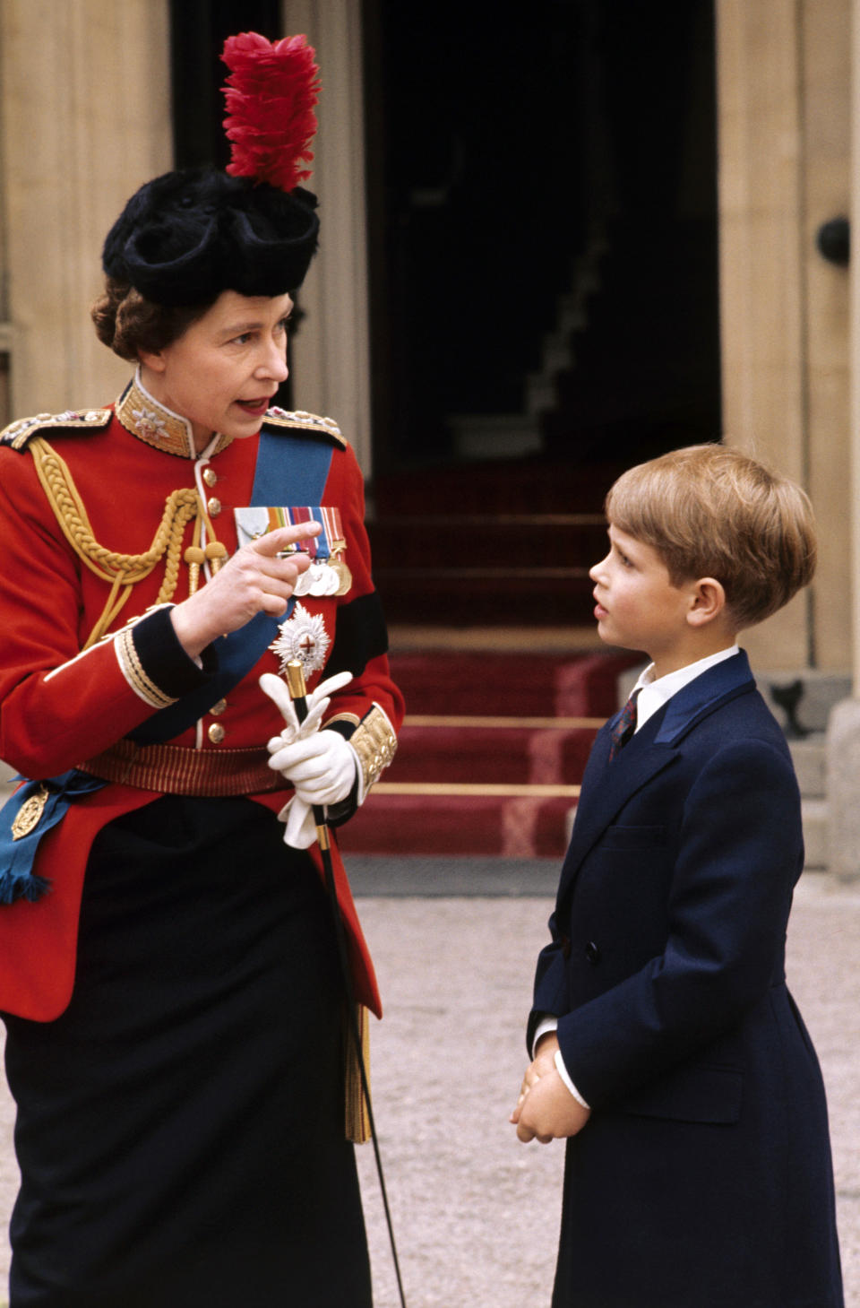 The Queen as she explains the details of the Trooping the Colour to her youngest son Prince Edward at Buckingham Palace. circa date 1972.