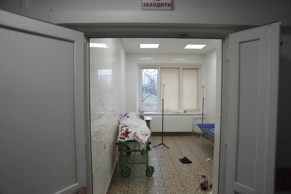 The lifeless body of teenager Ilya, fatally wounded by shelling, Iies on a stretcher at a maternity hospital converted into a medical ward in Mariupol, Ukraine, Wednesday, March 2, 2022. Russian forces have seized a strategic Ukrainian seaport and besieged another. Those moves are part of efforts to cut the country off from its coastline even as Moscow said Thursday it was ready for talks to end the fighting. (AP Photo/Evgeniy Maloletka)