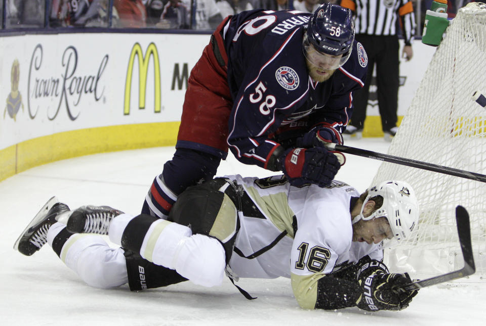 Columbus Blue Jackets' David Savard, top, knocks Pittsburgh Penguins' Brandon Sutter to the ice during the first period of Game 6 of a first-round NHL playoff hockey series Monday, April 28, 2014, in Columbus, Ohio. (AP Photo/Jay LaPrete)