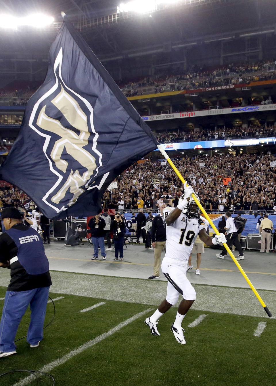 Central Florida wide receiver Josh Reese runs with his school's flag after the Fiesta Bowl NCAA college football game against Baylor, Wednesday, Jan. 1, 2014, in Glendale, Ariz. Central Florida won 52-42. (AP Photo/Ross D. Franklin)