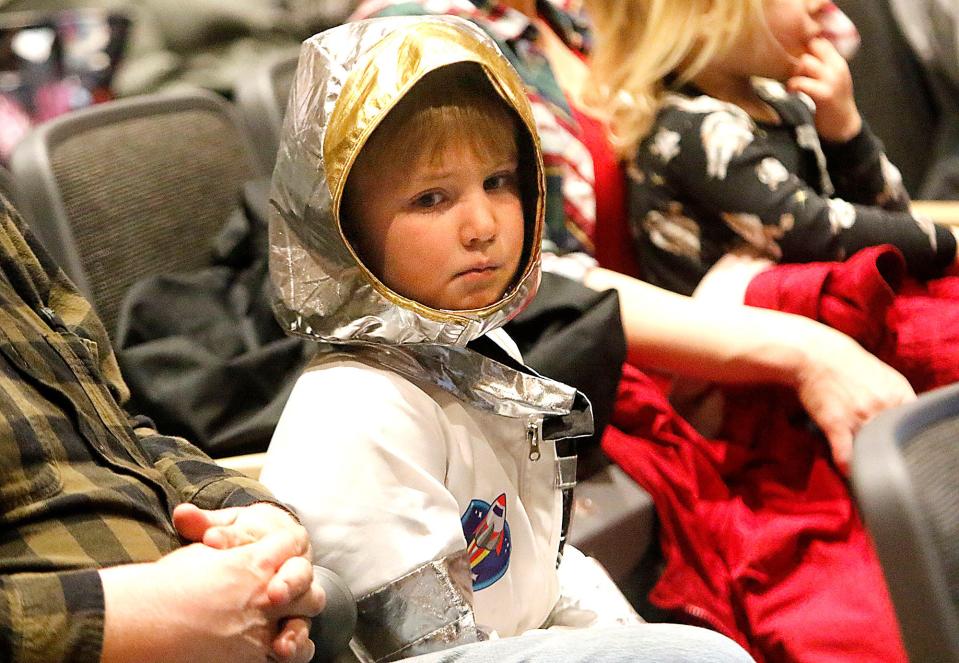 Dressed as an astronaut William Kocher, 5 of Polk, listens as Col. Robert Springer gives his Space Talk hosted by the Ashland County Historical Society at Ashland High School's Little Theater on Thursday, March 10, 2022.