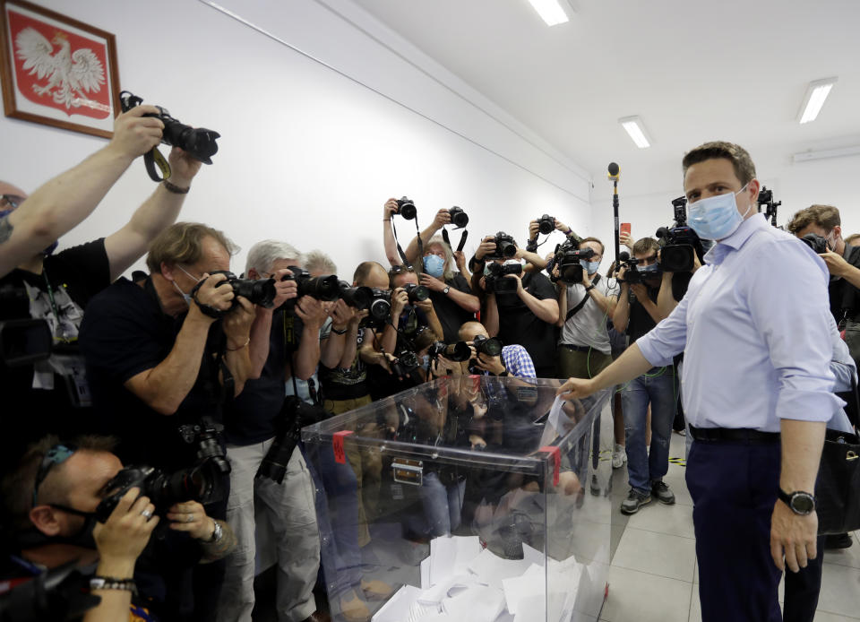 Presidential candidate Rafal Trzaskowski casts his vote during presidential election in Warsaw, Poland, Sunday, June 28, 2020. The election will test the popularity of incumbent President Andrzej Duda who is seeking a second term and of the conservative ruling party that backs him. (AP Photo/Petr David Josek)