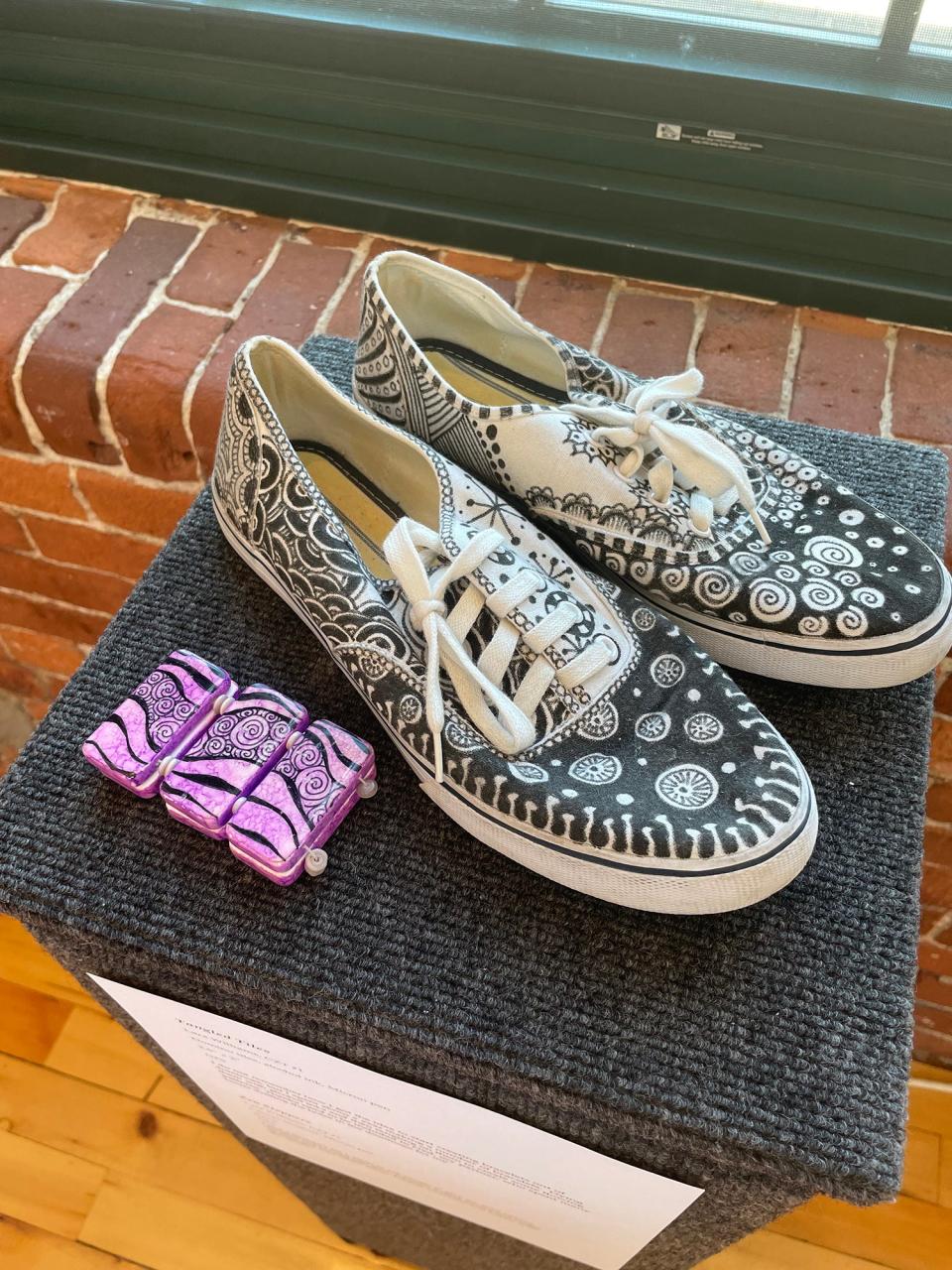Lara Williams, who used to work at Alternatives Unlimited (a precursor to Open Sky), created several pieces for the exhibit, including "Zen Steppers," a pair of sneakers, and "Tangled Tiles," a bracelet using Domino pieces.