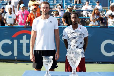 Jul 24, 2016; Washington, DC, USA; Ivo Karlovic of Croatia (L) and Gael Monfils of France (R) pose with the finalists and championship trophies, respectively, after their match in the men's singles final of the Citi Open at Rock Creek Park Tennis Center. Monfils won 5-7, 7-6(6), 6-4. Mandatory Credit: Geoff Burke-USA TODAY Sports