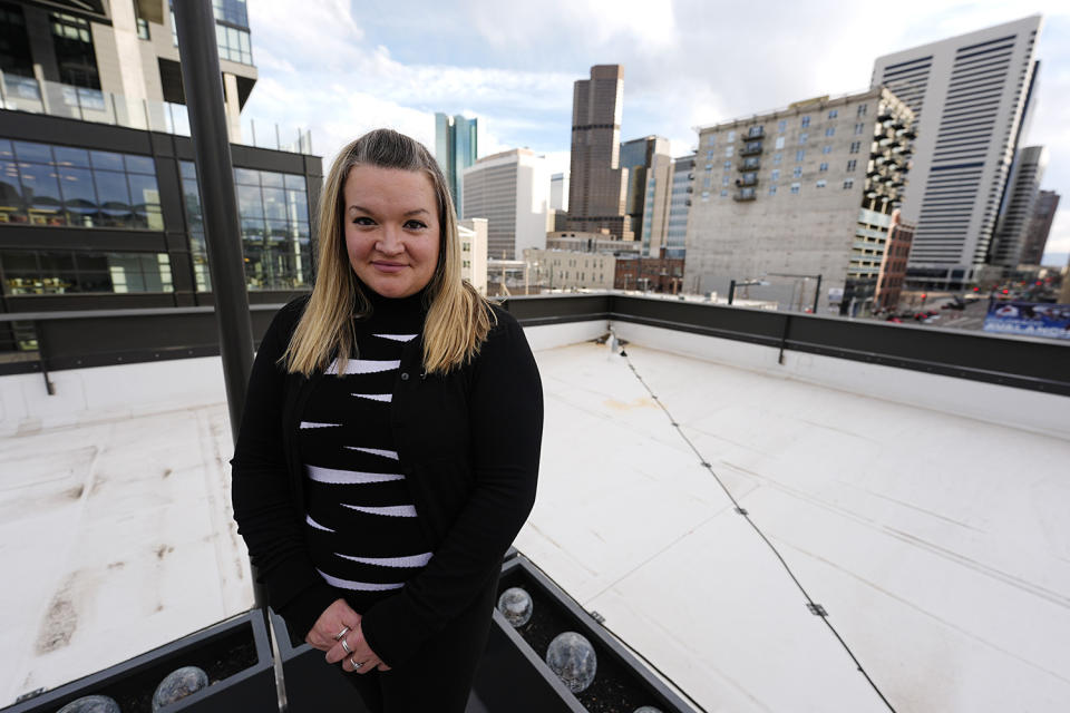 Missy Mendo, director of community outreach for The Rebels Project, which offers support to victims of mass shootings, is shown Friday, April 12, 2024, in Denver. Trauma still shadows the survivors of the horrific Columbine High School shooting as the attack's 25th anniversary approaches. (AP Photo/David Zalubowski)