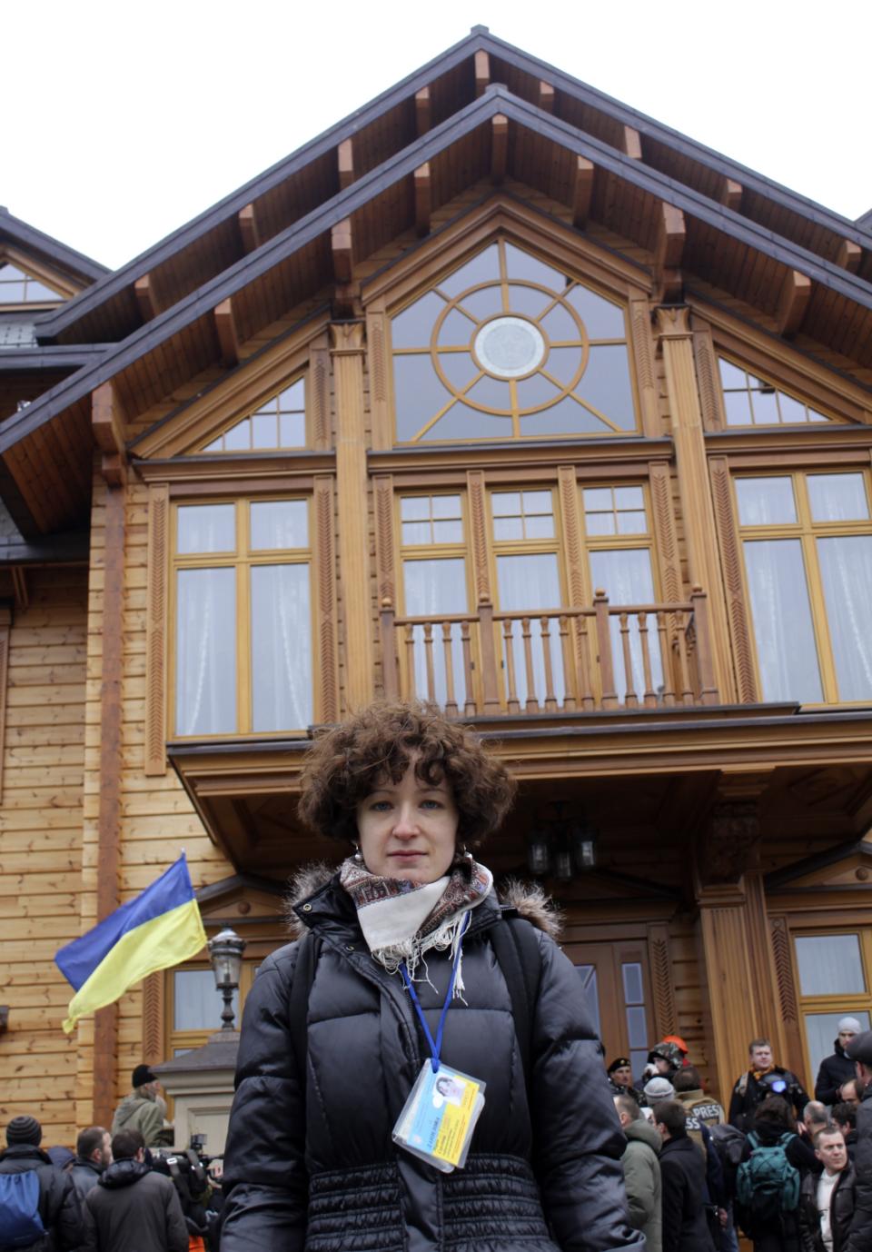 AP newswoman Maria Danilova poses for a photo in front of the Ukrainian President Yanukovych's countryside residence in Mezhyhirya, Kiev's region, Ukraine, Saturday, Feb, 22, 2014. For years, Maria has covered Ukraine’s President Viktor Yanukovych, a post-Soviet strongman, whose closely guarded suburban residence of Mezhygirya became a symbol of his alleged corruption and contempt for democracy.(AP Photo)