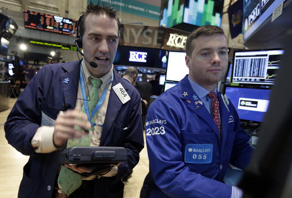 Trader Gregory Rowe, left, and specialist Frank Masiello work on the floor of the New York Stock Exchange Wednesday, April 23, 2014. The stock market slipped Wednesday after rallying for six straight days as investors worked through another round of quarterly earnings reports from U.S. companies. (AP Photo/Richard Drew)