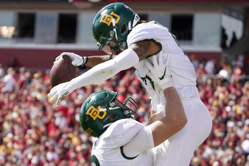 Baylor wide receiver Gavin Holmes celebrates with teammate tight end Ben Sims, left, after catching a 38-yard touchdown pass during the second half of an NCAA college football game against Iowa State, Saturday, Sept. 24, 2022, in Ames, Iowa. Baylor won 31-24. (AP Photo/Charlie Neibergall)