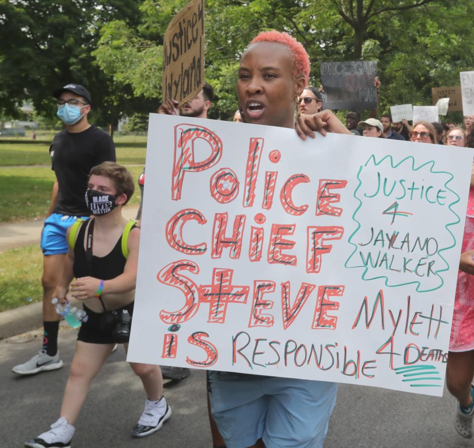 Marchers head south Monday along North Howard Street in Akron to protest the police shooting of Jayland Walker.