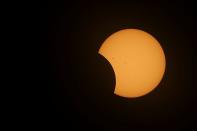 A solar eclipse is seen over Mexico