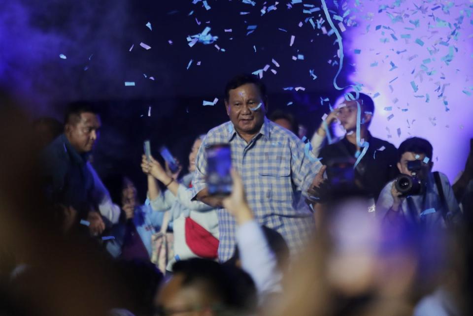 Indonesian Defence Minister and presidential candidate Prabowo Subianto (C) celebrates after claiming victory in the Presidential elections at Istora Stadium (EPA)