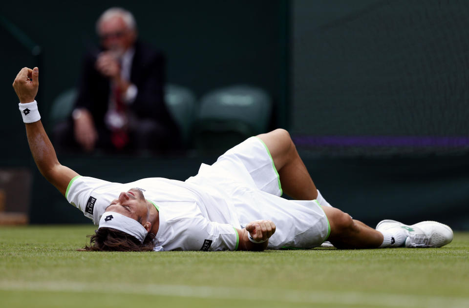 Spain's David Ferrer slips during his match against Argentina's Martin Alund during day Two of the Wimbledon Championships at The All England Lawn Tennis and Croquet Club, Wimbledon.