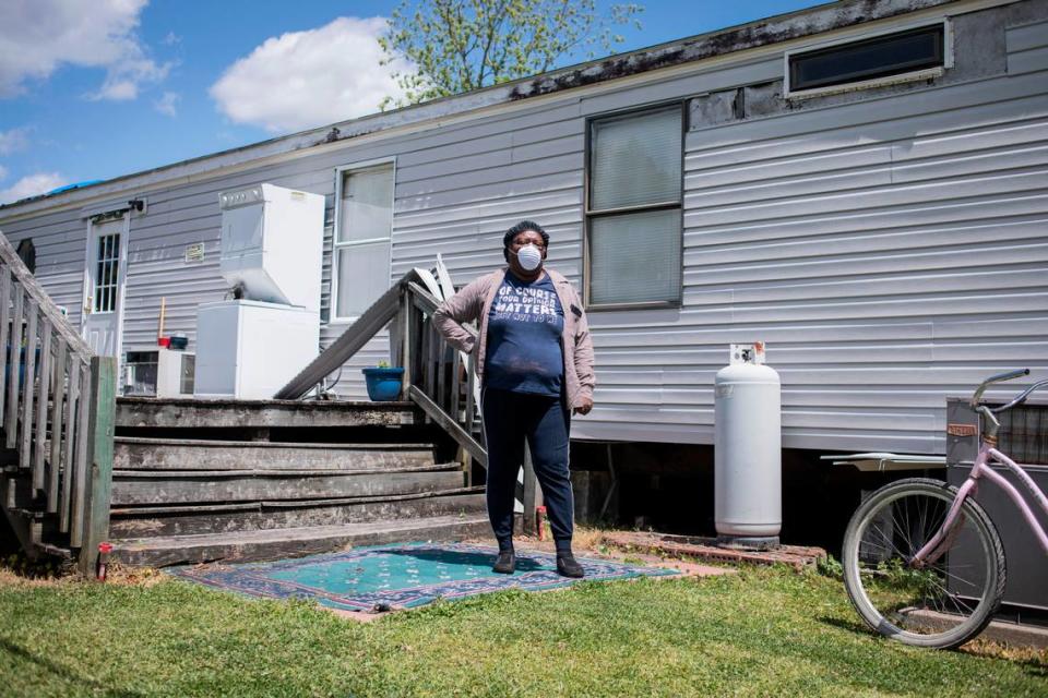Arlisha Hill poses for a portrait behind her home in Maple Hill, N.C., which was damaged in Hurricane Florence, on Monday, April 27, 2020. Hill lived in a FEMA trailer in her yard for 15 months and moved back into her unfinished home on March 14. Although a few things still need work, she’s happy to be safe and back in the comfort of her home, despite the threat of COVID-19.
