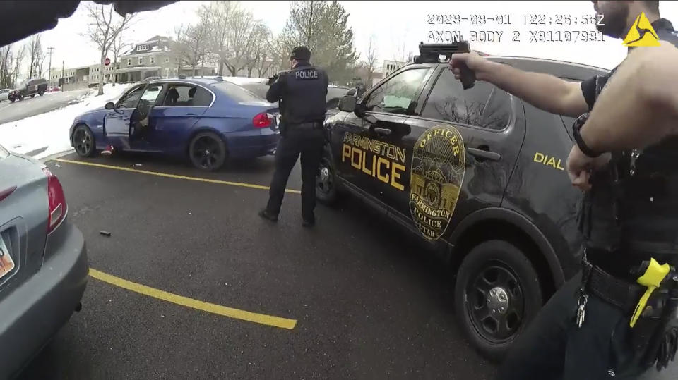 In this image taken from from police body camera video provided by the Farmington City, Utah, Police Department, police officers hold up their weapons during a traffic stop, Wednesday, March 1, 2023, in Farmington, Utah. The footage released by the suburban police department in Utah on Wednesday, Mach 8, 2023, shows five officers opening rounds of fire into all sides of a car after they can be heard alerting each other that the driver, 25-year-old Chase Allan, has a gun. The Allan family has since raised questions about police actions. (Farmington City Police Department via, AP)