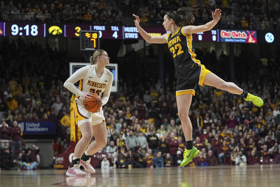 Minnesota guard Grace Grocholski (25) looks to shoot as Iowa guard Caitlin Clark (22) defends during the first half of an NCAA college basketball game Wednesday, Feb. 28, 2024, in Minneapolis. (AP Photo/Abbie Parr)