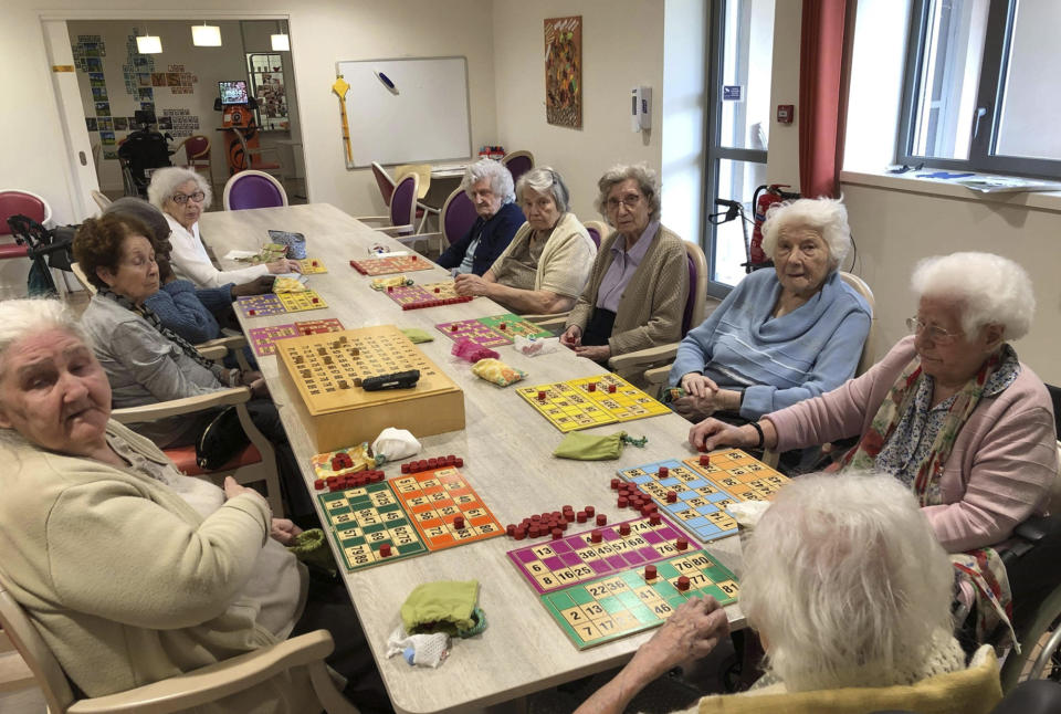 In this photo provided by the Vilanova nursing home, residents play inside the Vilanova nursing home on April 30 2020 in Corbas, central France. As the coronavirus cut a deadly path through nursing homes, staff locked themselves in with the 106 residents at this care home to stop COVID-19 coronavirus from infecting and killing the vulnerable older adults in their care, and they have not had any people falling victim to the virus.(Valerie Martin via AP)