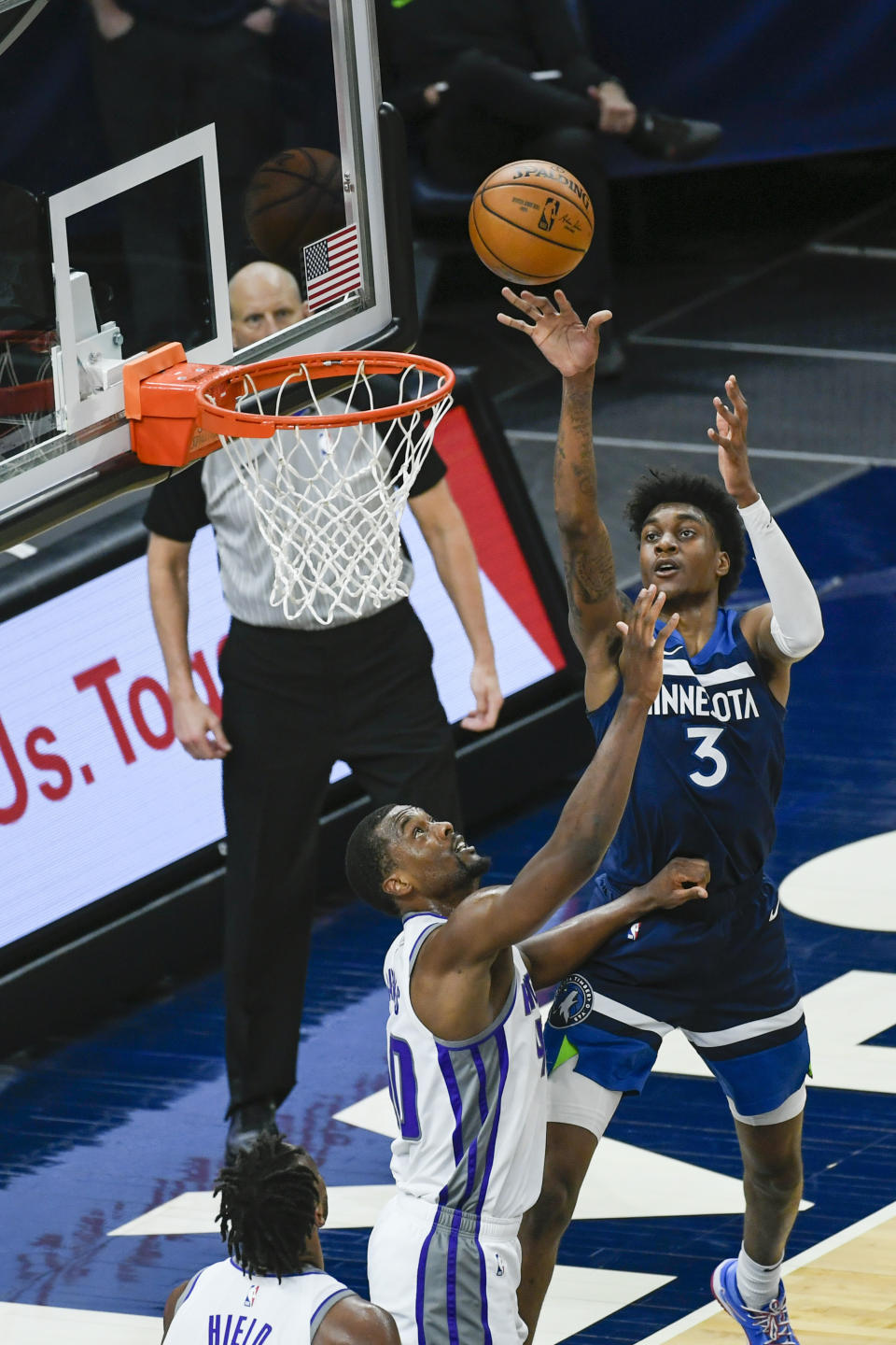 Minnesota Timberwolves forward Jaden McDaniels (3) shoots over Sacramento Kings forward Harrison Barnes during the first half of an NBA basketball game Monday, April 5, 2021, in Minneapolis. (AP Photo/Craig Lassig)