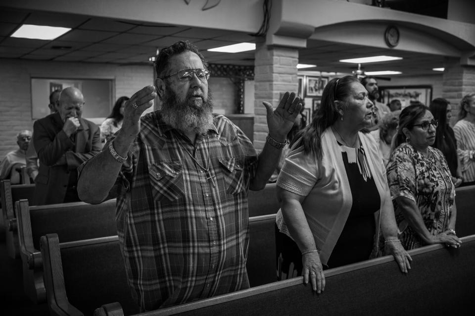 David Hernandez, left, prays with his wife Mary at the Templo Cristiano church on May 29, 2022.<span class="copyright">David Butow for TIME</span>