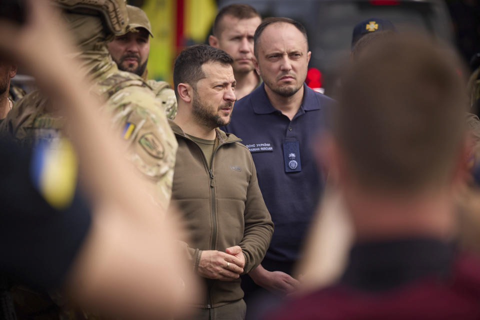 In this photo provided by the Ukrainian Presidential Press Office, Ukrainian President Volodymyr Zelenskyy visits the flooding hit areas in Kherson, Ukraine, Thursday, June 8, 2023. (Ukrainian Presidential Press Office via AP)