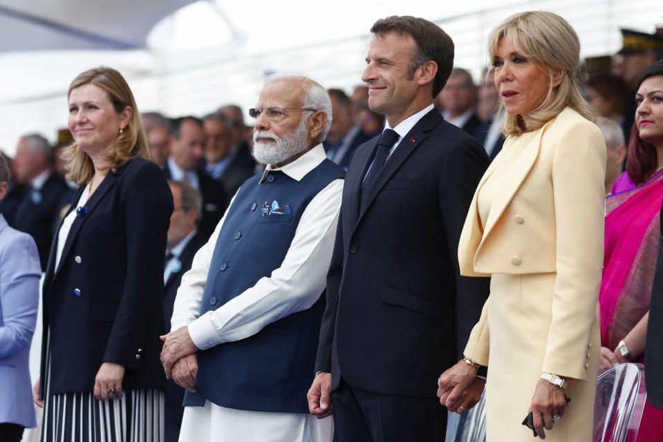 France's President Emmanuel Macron, second right, first lady Brigitte Macron, right, and India's Prime Minister Narendra Modi attend the annual Bastille Day military parade, in Paris, Friday, July 14, 2023. India is the guest of honor at this year's Bastille Day parade, with Prime Minister Narendra Modi set to watch in the presidential tribune alongside French President Emmanuel Macron. At left is Yael Braun-Pivet, president of the National Assembly. (Gonzalo Fuentes/Pool via AP)