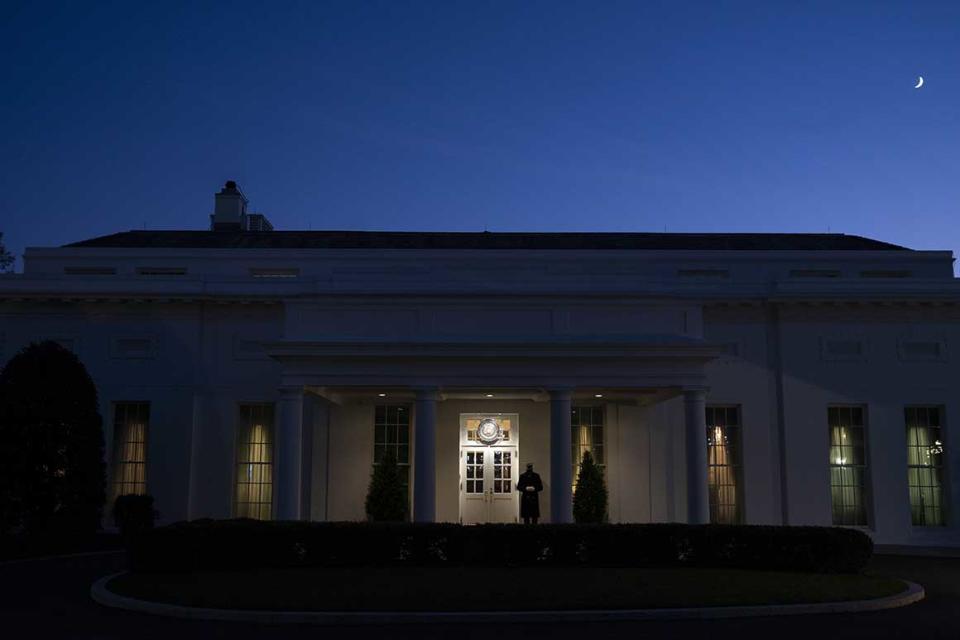 A Marine stands outside the entrance to the West Wing of the White House, signifying that President Donald Trump is in the Oval Office, Wednesday, Nov. 18, 2020, in Washington. (AP Photo/Evan Vucci)