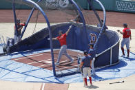 Boston Red Sox's J.D. Martinez swings in the batting cage during baseball training camp at Fenway Park, Tuesday, July 7, 2020, in Boston. (AP Photo/Elise Amendola)