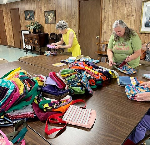 Members of the Shelby County volunteer group purSEWverance are shown making purses for the girls and young women of Zambia as part of Sew Powerful's annual "Sew-a-Thon" fundraiser.