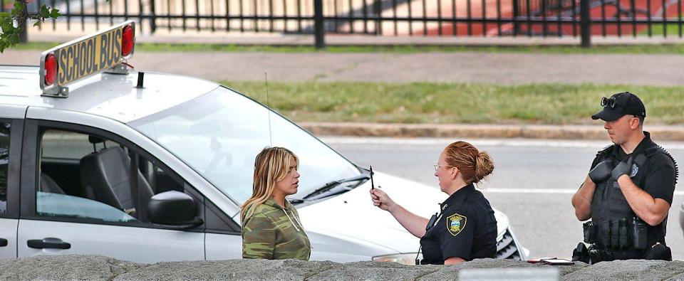 Quincy police officers Cheryl Potter and Christian Donovan conduct a field sobriety test on the driver of a school van on Southern Artery in Quincy. The woman was taken into custody on Wednesday, June 1, 2022.