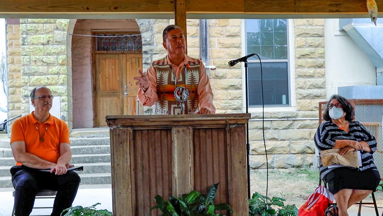 The Rev. David Wilson speaks at a remembrance service near Okemah as the Rev. Jimmy Nunn, Oklahoma Methodist bishop, at left, and Dr. Delores Subia Bigfoot, a metro-area child psychologist, on the right, listen to his remarks.