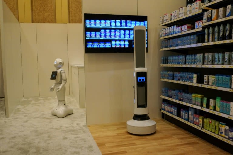 Pepper of SoftBank Robotics (L) and Tally of Simbe Robotics (R) are teaming up to work with retailers: Pepper interacts with customers while Tally scans shelves to monitor inventory in this demo from SoftBank at the Consumer Electronics Show