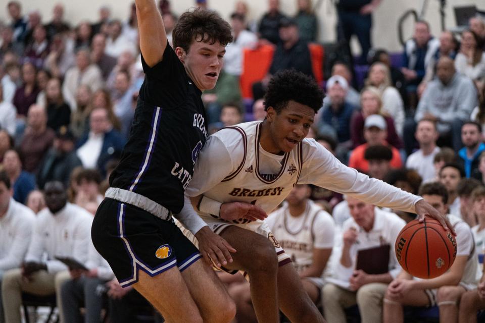 Brebeuf Jesuit senior guard Evan Haywood (1) drives to the basket while being defended by Guerin Catholic senior guard Andy Caron (4) during the IHSAA Class 3A Sectional Championship March 2, 2024, at Guerin Catholic High School in Noblesville, Indiana.