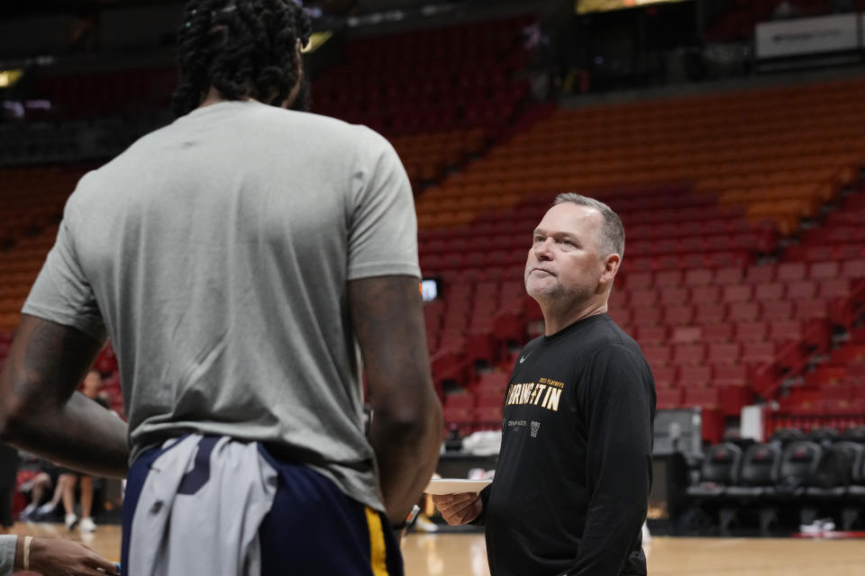 Denver Nuggets head coach Michael Malone, right, talks to a player during NBA basketball practice at the Kaseya Center in Miami, Tuesday, June 6, 2023, in Miami. The Nuggets face the Miami heat in Game 3 of the NBA Finals on Wednesday. (AP Photo/Marta Lavandier)