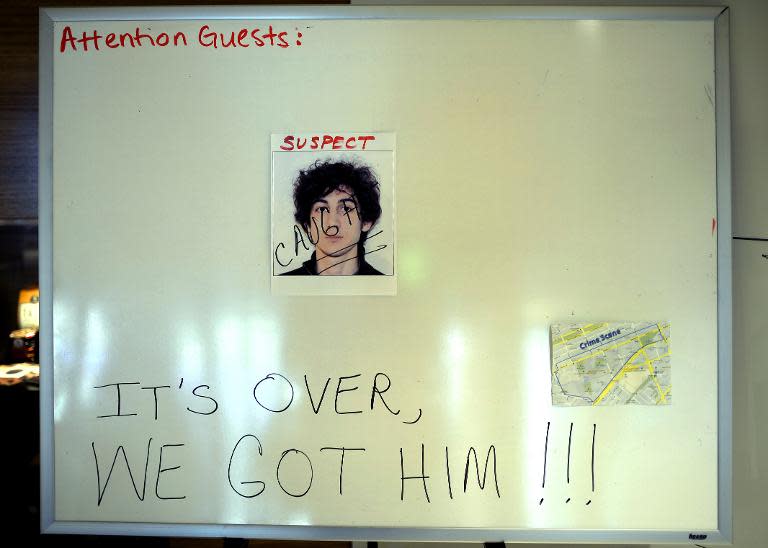 A sign in a Boston hotel lobby on April 20, 2013, shows a photo of Dzhokhar Tsarnaev, 19, the morning after he was captured