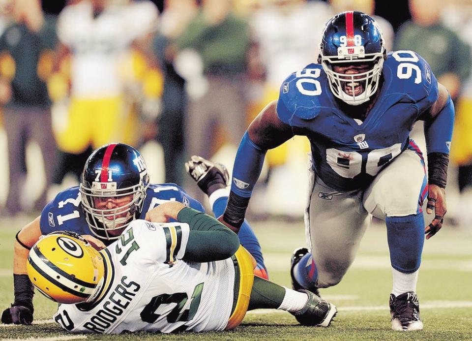 Former Giants defensive end Jason Pierre-Paul celebrates a sack of Packers quarterback Aaron Rodgers in a 2011 game.