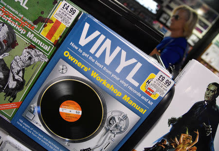 A shopper passes a book about vinyl music at an HMV music store in London, Britain, July 20, 2018. REUTERS/Toby Melville